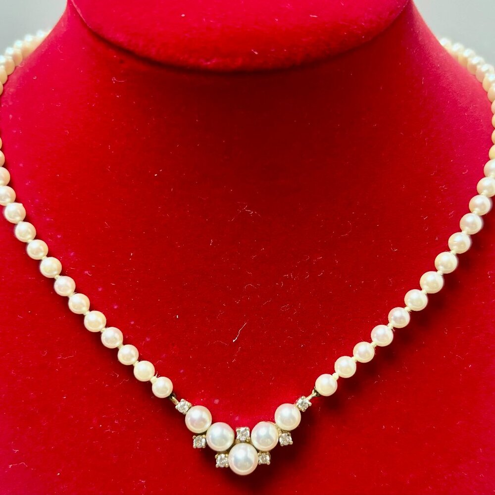 White cultured pearl and round brilliant Diamond 14k yellow gold necklace.